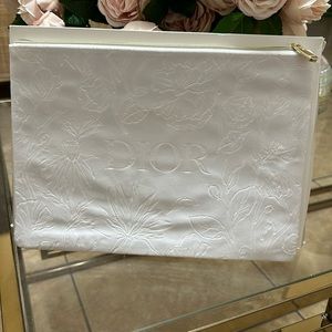 DIOR white velvet makeup case.